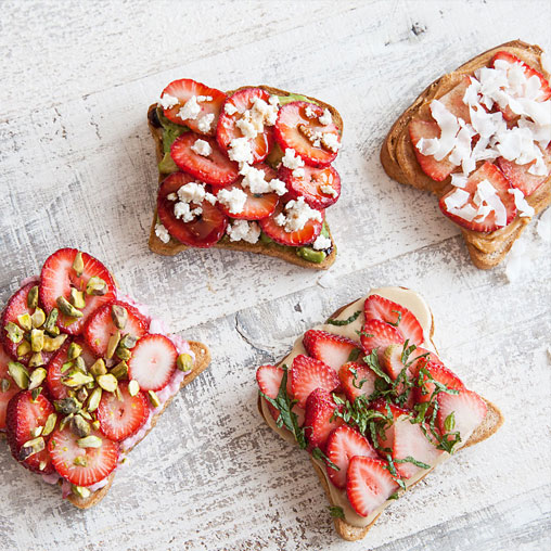 Strawberry toast with cheese, seeds, coconut and herbs for toppings.